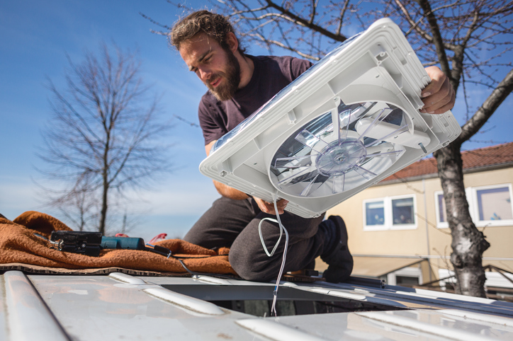 DIYer installing a ceiling fan in his RV